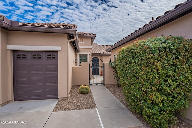 doorway to property with a garage