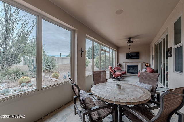 sunroom / solarium featuring ceiling fan