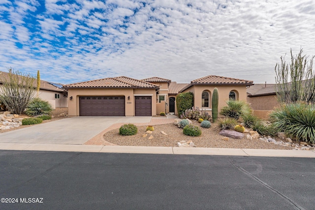 mediterranean / spanish-style home with a garage