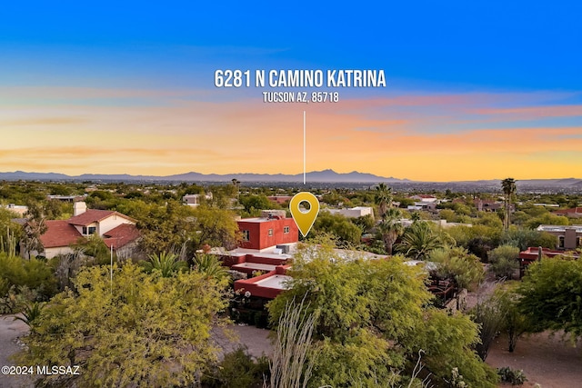 aerial view at dusk featuring a mountain view