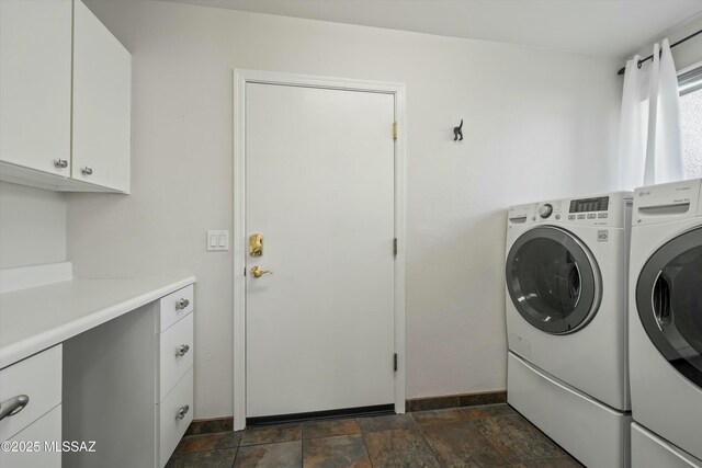 clothes washing area featuring cabinet space, stone finish flooring, baseboards, and washer and dryer