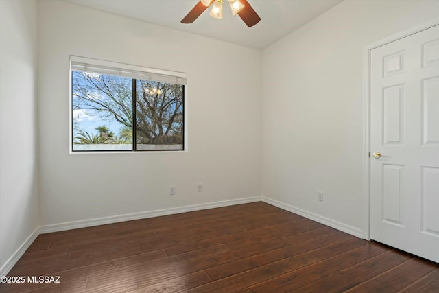 unfurnished bedroom with dark wood-type flooring, baseboards, and a ceiling fan