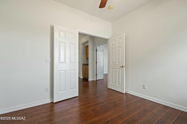 unfurnished bedroom with ceiling fan, baseboards, and dark wood finished floors