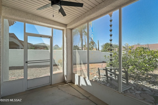 unfurnished sunroom with a ceiling fan