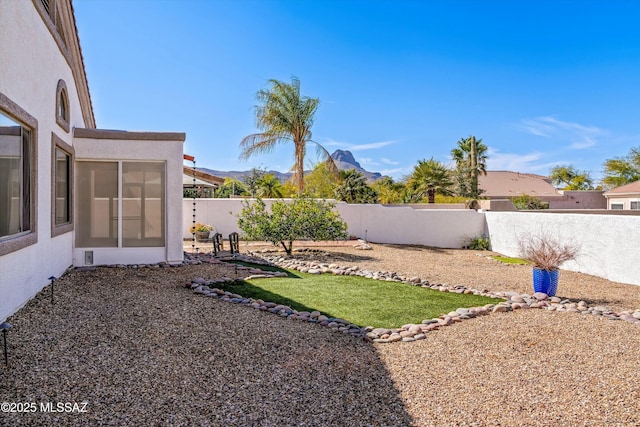 view of yard featuring a fenced backyard and a mountain view