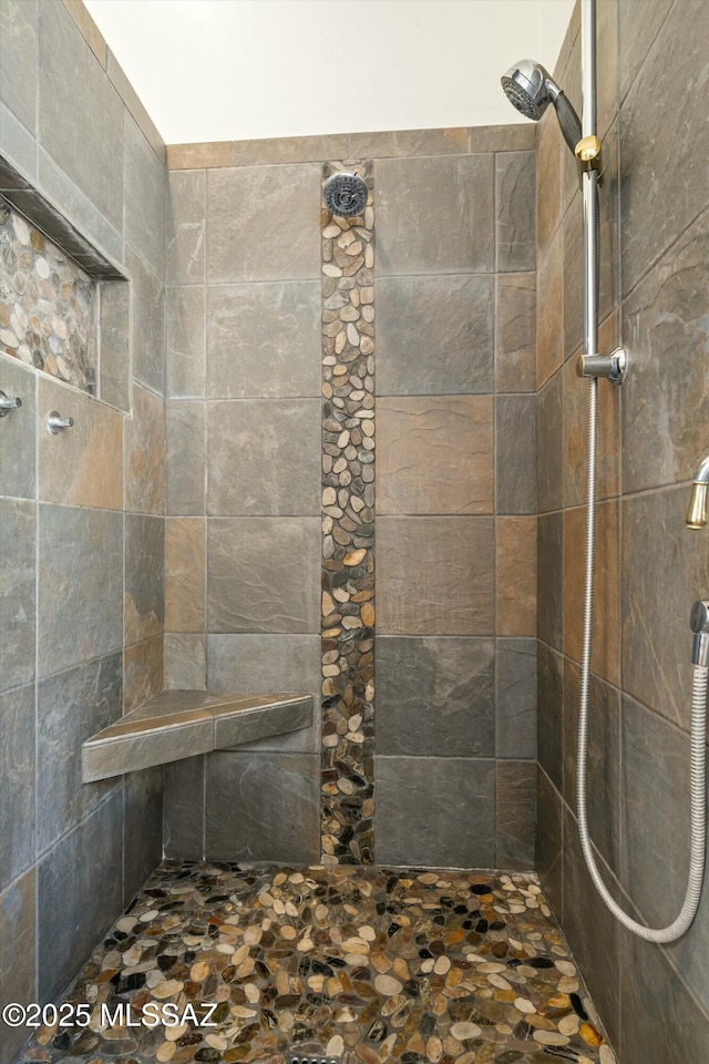 bathroom with a tile shower