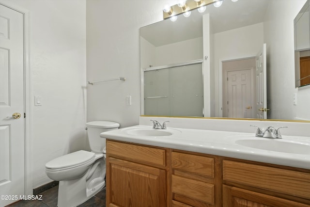 full bathroom with double vanity, an enclosed shower, toilet, and a sink