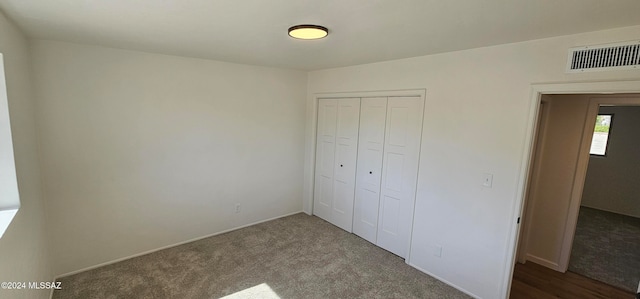 unfurnished bedroom with carpet and a closet