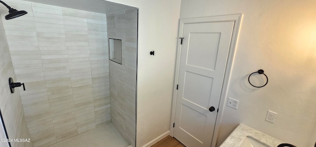 bathroom featuring vanity and a tile shower