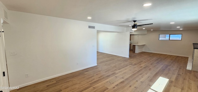 unfurnished living room with ceiling fan and light wood-type flooring