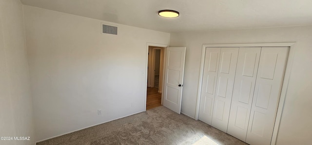 unfurnished bedroom featuring a closet and carpet flooring