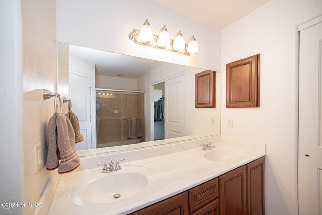 bathroom with vanity and a shower with shower door