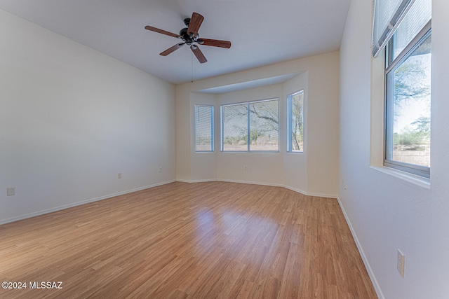 unfurnished room featuring light hardwood / wood-style floors and ceiling fan