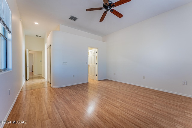 spare room with light wood-type flooring and ceiling fan