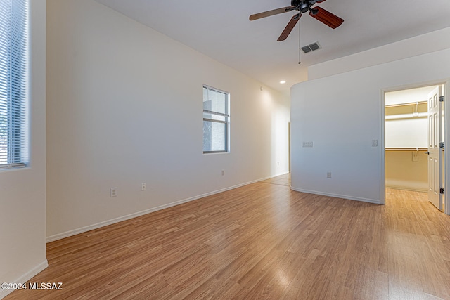 empty room with light wood-type flooring and ceiling fan