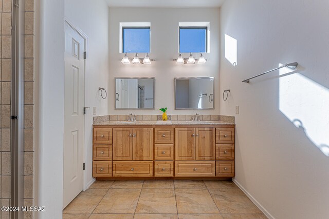 bathroom with vanity and a high ceiling