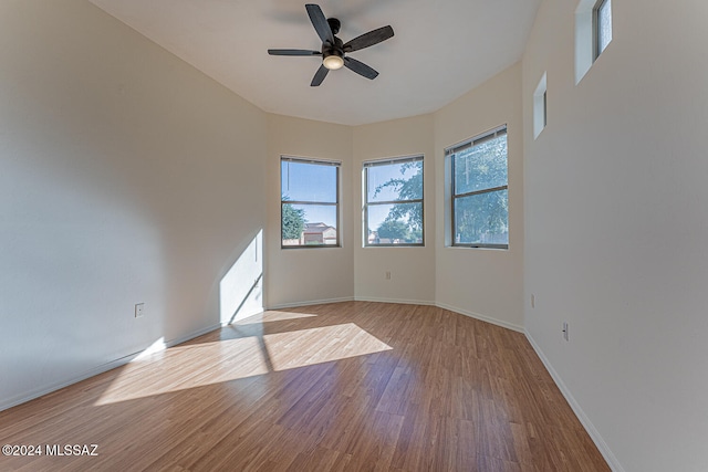 empty room with light hardwood / wood-style floors and ceiling fan