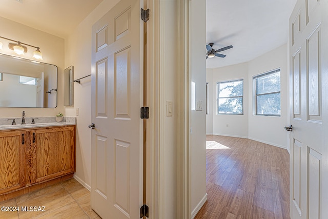 bathroom with vanity, hardwood / wood-style floors, and ceiling fan