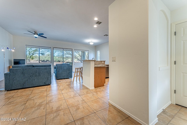 unfurnished living room with ceiling fan