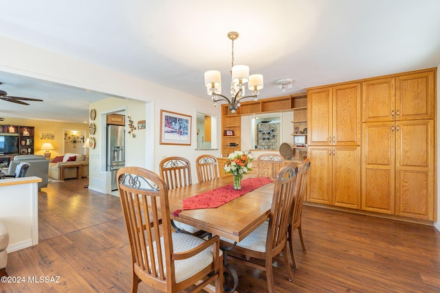 dining room with ceiling fan with notable chandelier and dark hardwood / wood-style floors