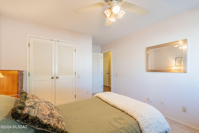 bedroom with carpet, ceiling fan, and a closet