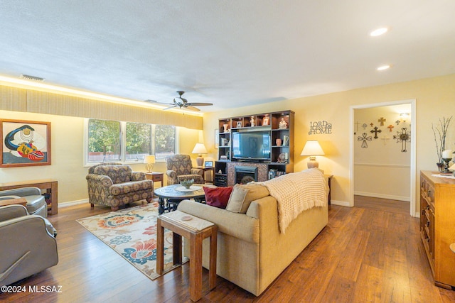 living room featuring ceiling fan and wood-type flooring