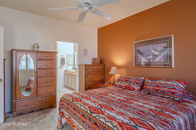 tiled bedroom featuring ensuite bathroom and ceiling fan