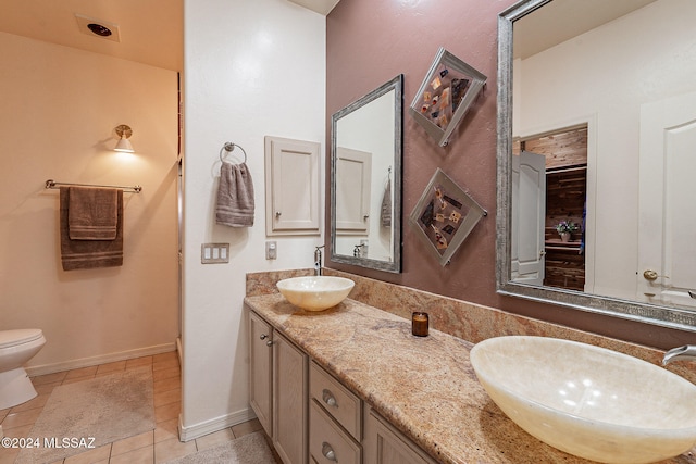 bathroom featuring toilet, vanity, and tile patterned floors