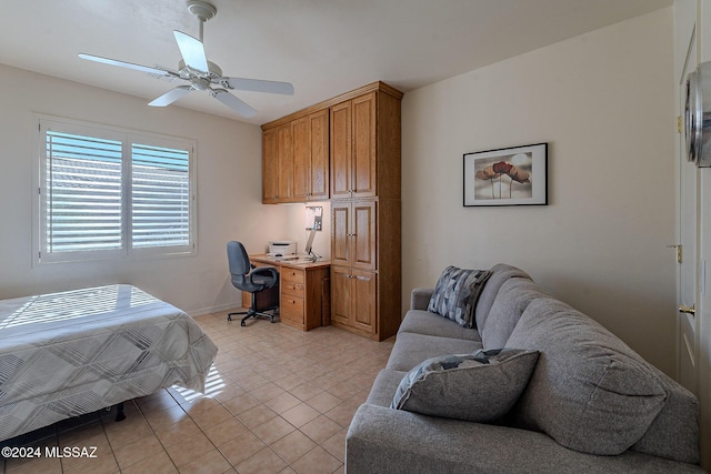 bedroom with a desk, light tile patterned floors, baseboards, and ceiling fan