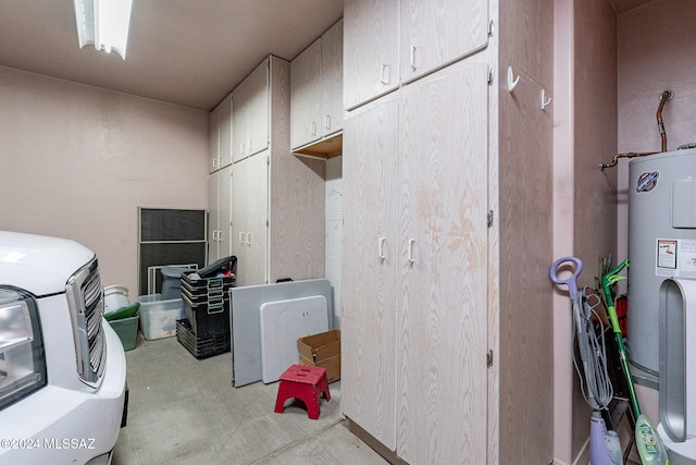 interior space with water heater, cabinets, and independent washer and dryer