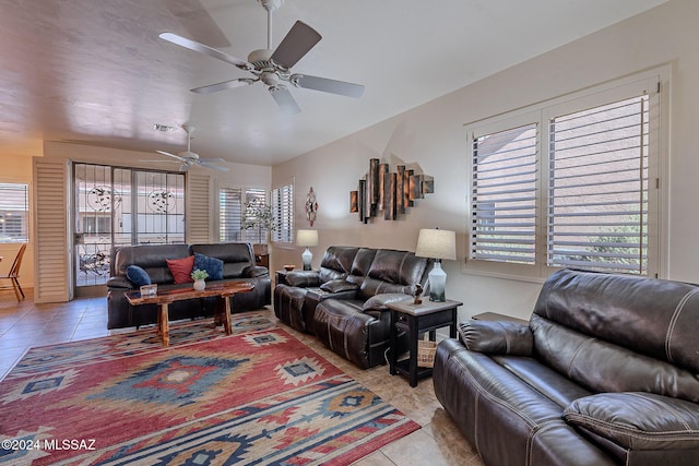 living area with plenty of natural light, light tile patterned flooring, and a ceiling fan