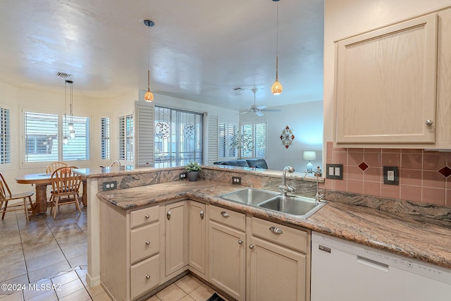 kitchen with dishwasher, a sink, light tile patterned floors, tasteful backsplash, and pendant lighting