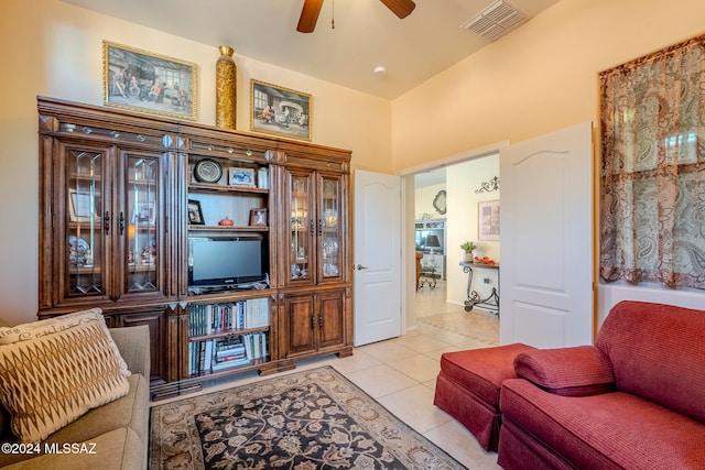 tiled living room with a high ceiling and ceiling fan