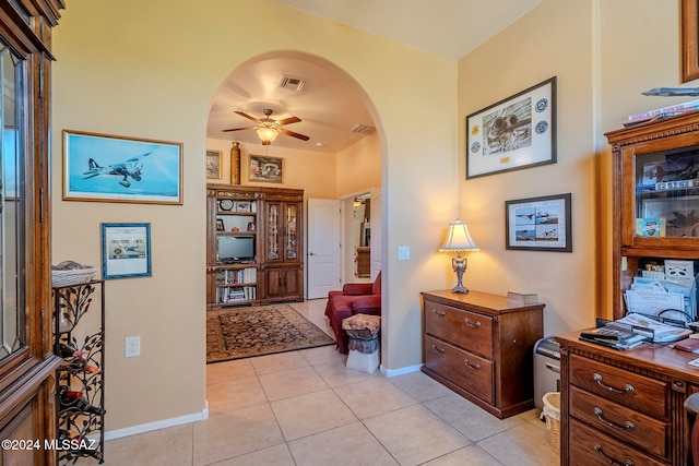 foyer entrance with light tile patterned flooring and ceiling fan