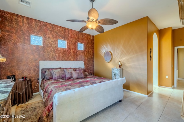 tiled bedroom featuring ceiling fan