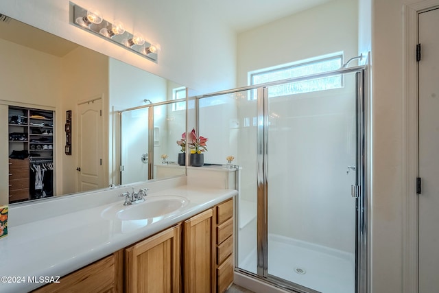 bathroom with walk in shower and vanity