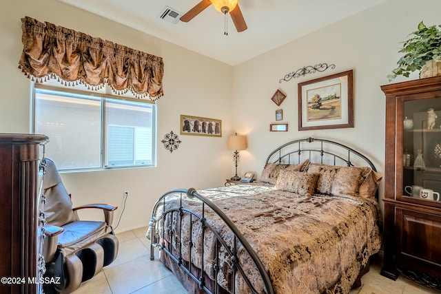 tiled bedroom featuring ceiling fan