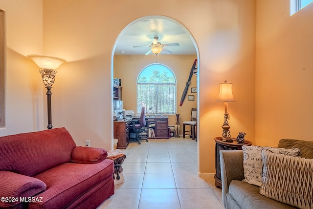 tiled living room with ceiling fan