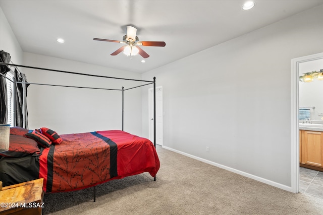 carpeted bedroom featuring ceiling fan and sink