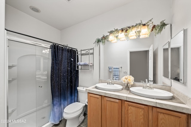 bathroom with curtained shower, tile patterned floors, vanity, and toilet