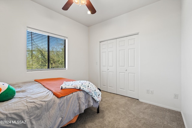 bedroom with ceiling fan, carpet flooring, and a closet