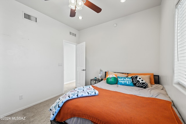 bedroom with carpet flooring, multiple windows, and ceiling fan