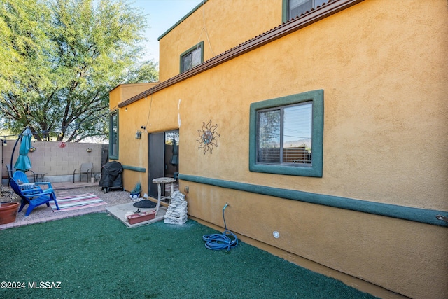 view of home's exterior with a patio and a yard