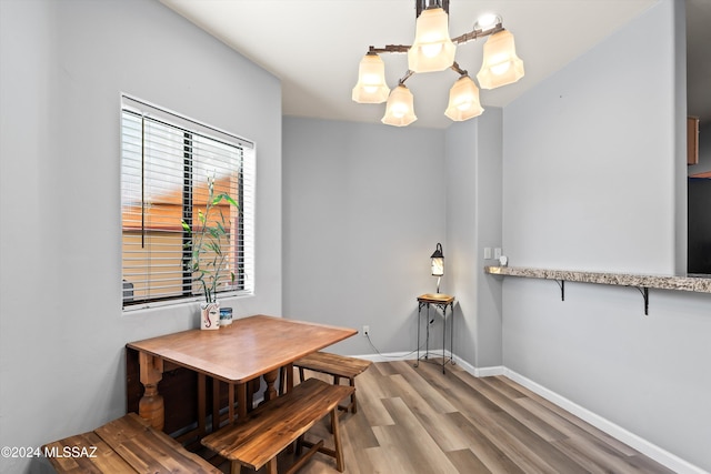 dining space featuring hardwood / wood-style floors and a notable chandelier