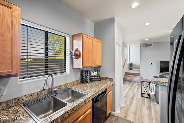 kitchen featuring dishwasher, wood-type flooring, and sink