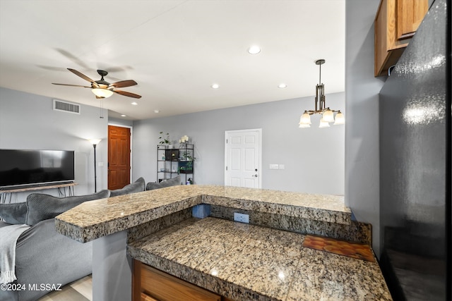 kitchen with pendant lighting, light hardwood / wood-style flooring, and ceiling fan