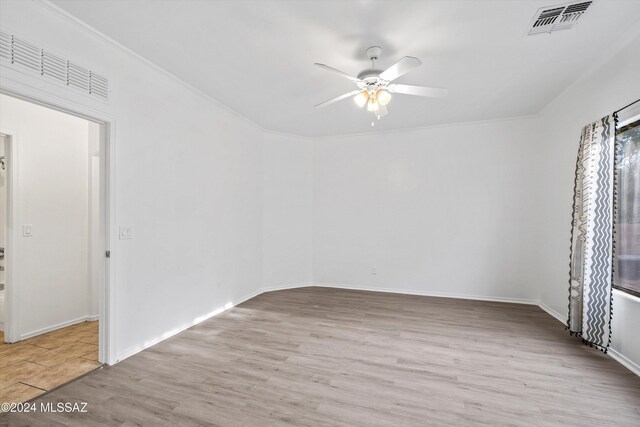 empty room with light wood-type flooring, ceiling fan, and ornamental molding