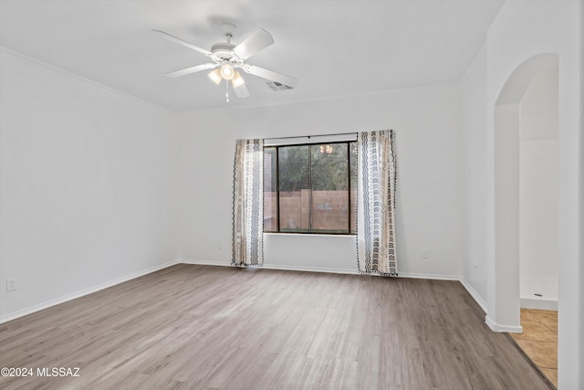 empty room featuring light hardwood / wood-style flooring and ceiling fan