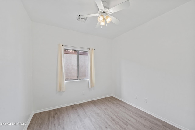 spare room with light hardwood / wood-style flooring and ceiling fan