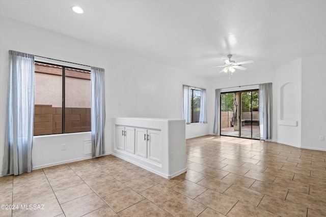 empty room featuring light tile patterned floors and ceiling fan